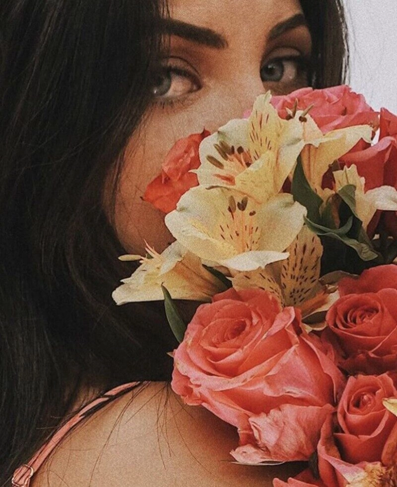 ảnh cô gái cầm hoa che mặt buồn